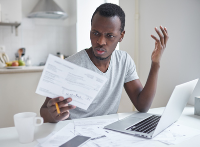 Man looking at bills and frustrated with budget